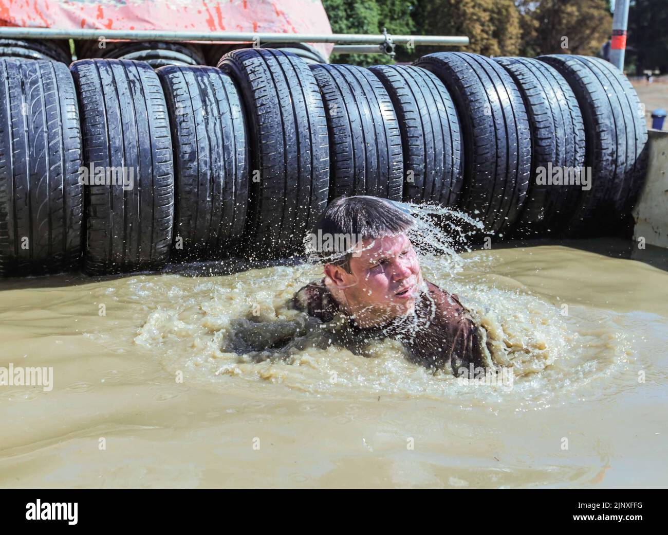 London UK 14 August 2022 Competitors of the Tough Mudder event in Morden Park London cherishing the challenge of conquering the different obstacles put between them and victory, Paul Quezada-Neiman/Alamy Live News Stock Photo