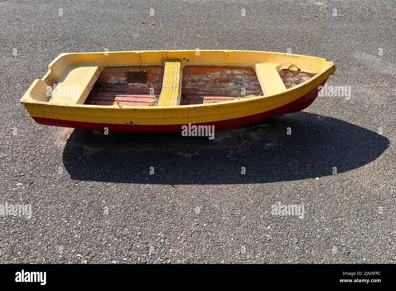 Small wooden boat parked on the street. Milan, Italy - August 2022 Stock Photo
