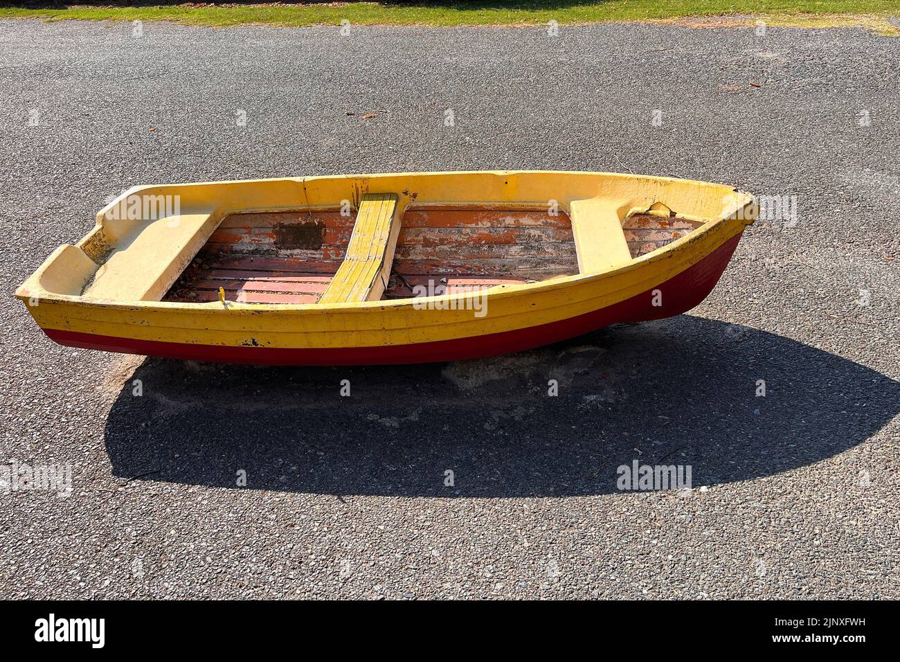 Small wooden boat parked on the street. Milan, Italy - August 2022 Stock Photo