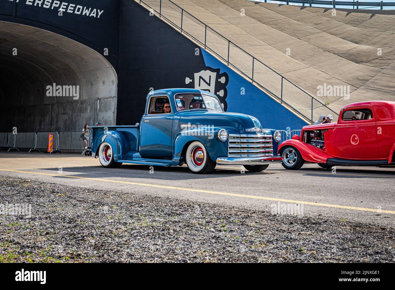 Lebanon, TN - May 14, 2022: Wide angle front corner view of a 1949 Chevrolet Stepside Pickup Truck driving on a road leaving a local car show. Stock Photo
