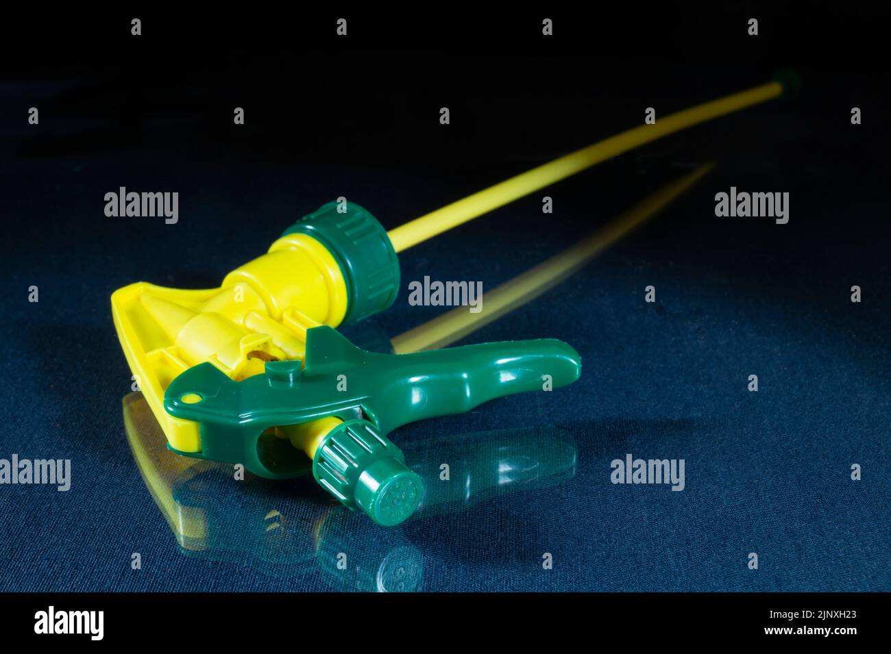 Garden tools on a black background. Plastic tool close-up. A device for spraying in the garden Stock Photo