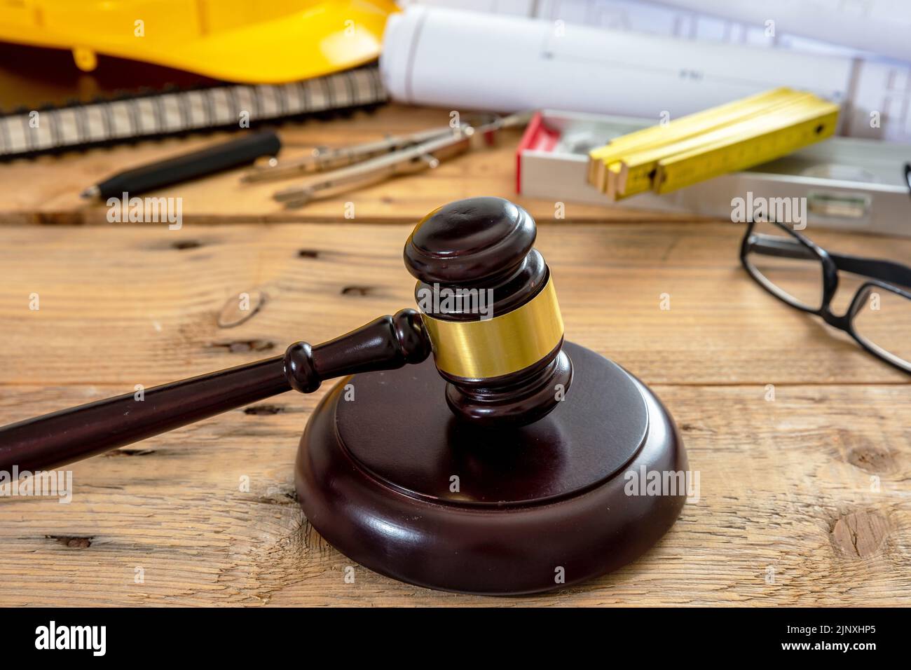 Construction and Labor law. Judge gavel and engineering tools on wooden