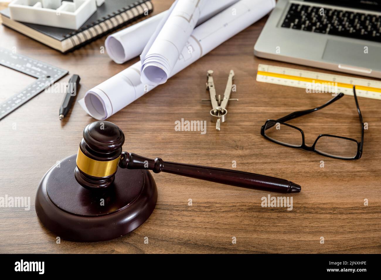 Labor and Construction law concept. Judge gavel and engineering tools on wooden table, close up view. Stock Photo