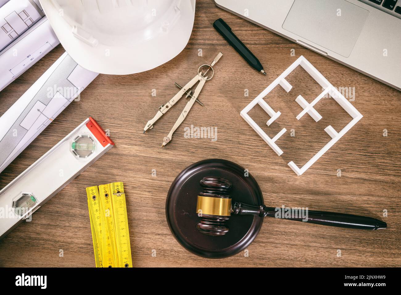 Labor and Construction law flat lay. Judge gavel and design tools on wooden table, top view. Stock Photo
