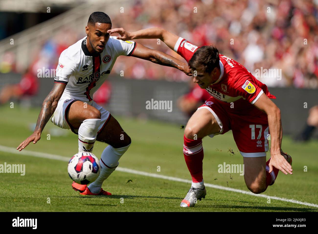 Sheffield United's Max Lowe battles with Middlesbrough's Paddy McNair during the Sky Bet Championship match at the Riverside Stadium, Middlesbrough. Picture date: Sunday August 14, 2022. Stock Photo