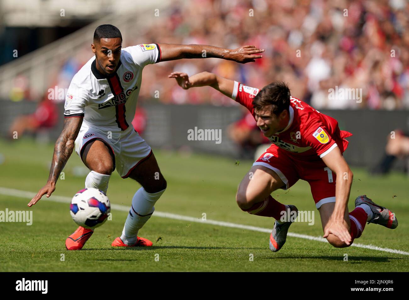 Sheffield United's Max Lowe battles with Middlesbrough's Paddy McNair during the Sky Bet Championship match at the Riverside Stadium, Middlesbrough. Picture date: Sunday August 14, 2022. Stock Photo