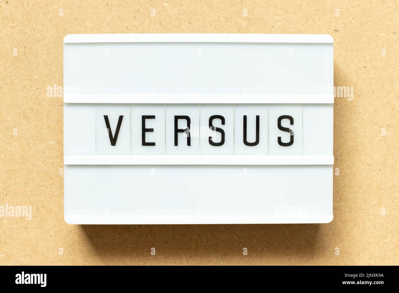 Lightbox with word versus on wood background Stock Photo