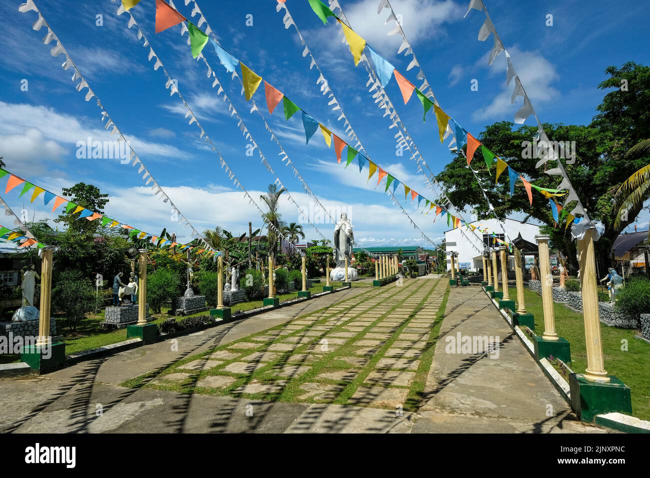 Siargao Island, Philippines - July 2022: Garden of Our Lady of Mount Carmel Parish Church on July 19, 2022 in Del Carmen, Siargao Island, Philippines. Stock Photo