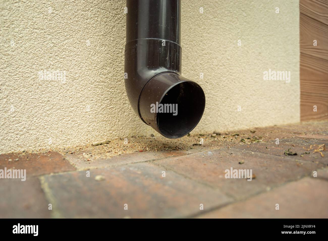 Plastic brown gutter hole near the ground Stock Photo