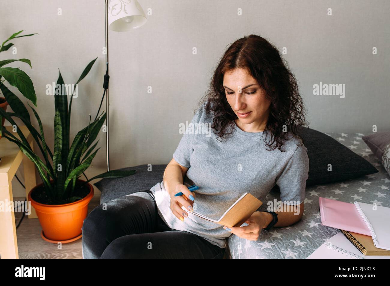 Woman working from home studying. Advanced training, retraining profession. Stock Photo