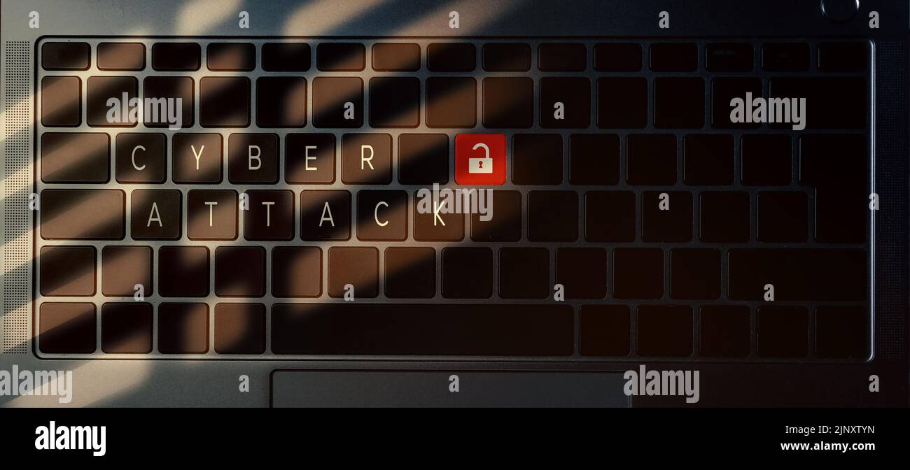 Banner top view of laptop keyboard with 'Cyber attack' message on buttons. Security alert data Stock Photo