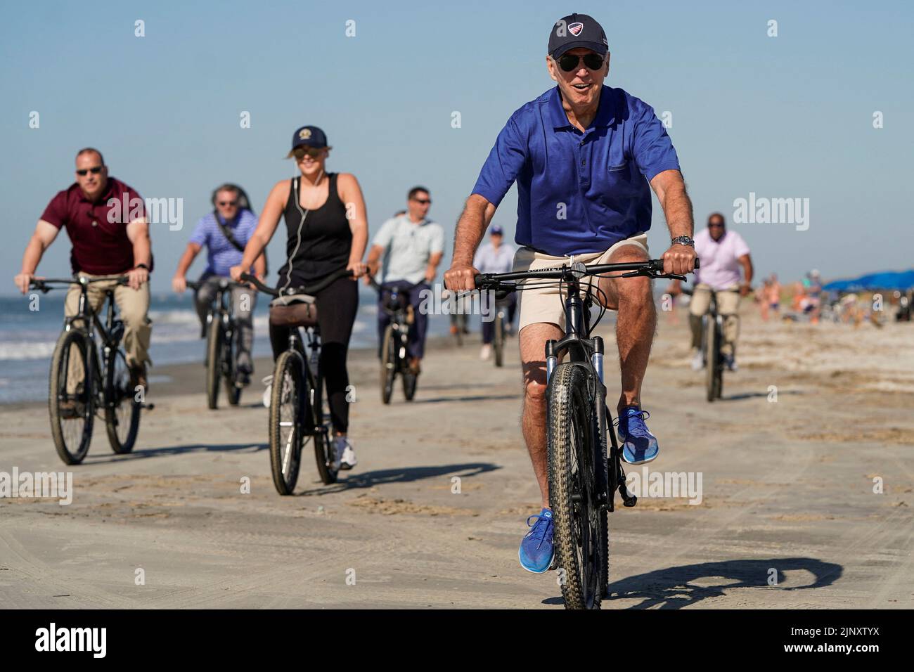 U.S. President Joe Biden rides a bicycle on the beach on Kiawah Island, South Carolina, U.S., August 14, 2022.  REUTERS/Joshua Roberts Stock Photo