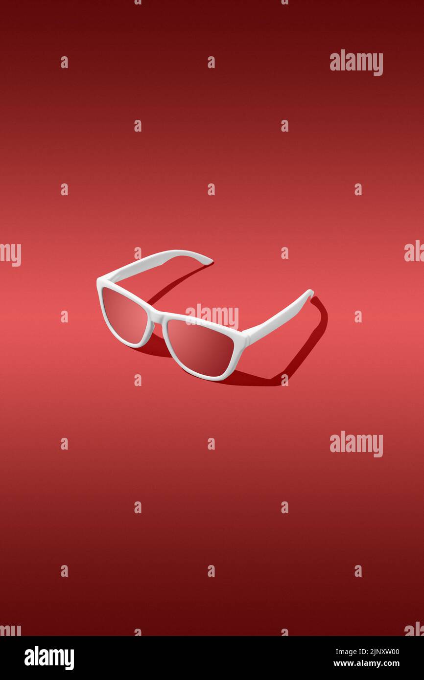 Red sunglasses with red gradient background. Studio shot Stock Photo