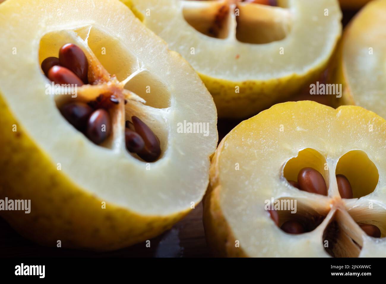 Closeup of Japanese quince. Crosssectioned fruit with seeds in a seed box. Japanese quince