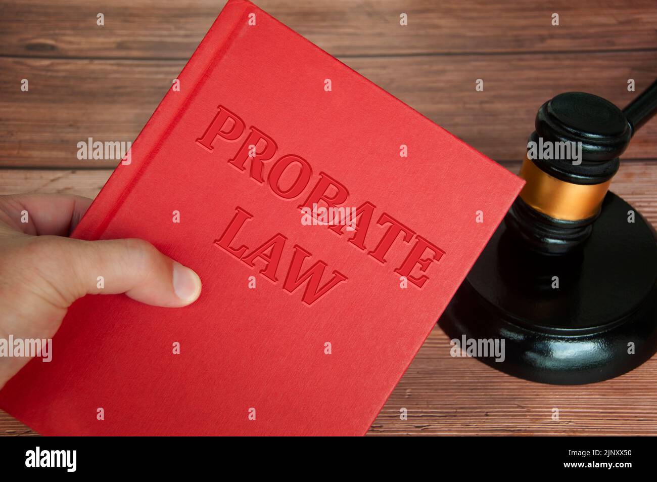 Hand holding Probate Law book with gavel background. Law concept. Stock Photo