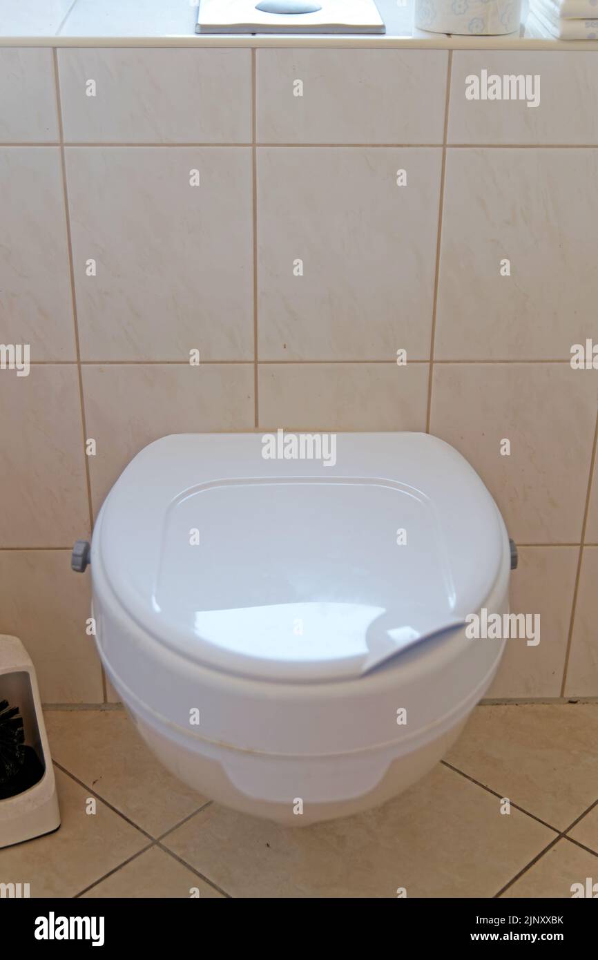 Help for people with disabilities: toilet with booster seat Stock Photo