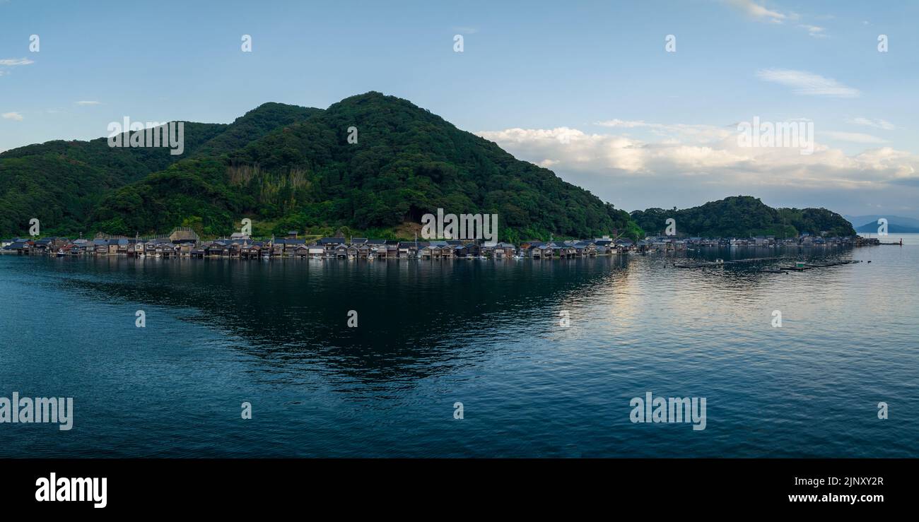 Houses in small fishing village between water and mountain at blue hour Stock Photo