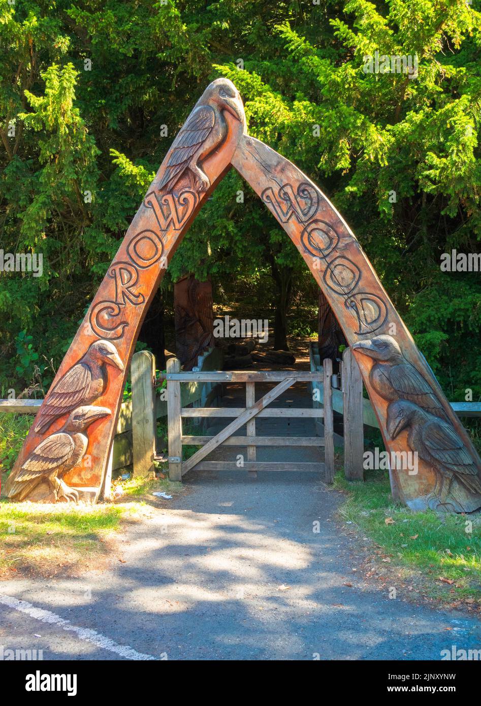 Carved wooden arch at the entrance to Crow Wood an area of woodland for fun and study at North Yorkshire Moors Centre Danby Stock Photo
