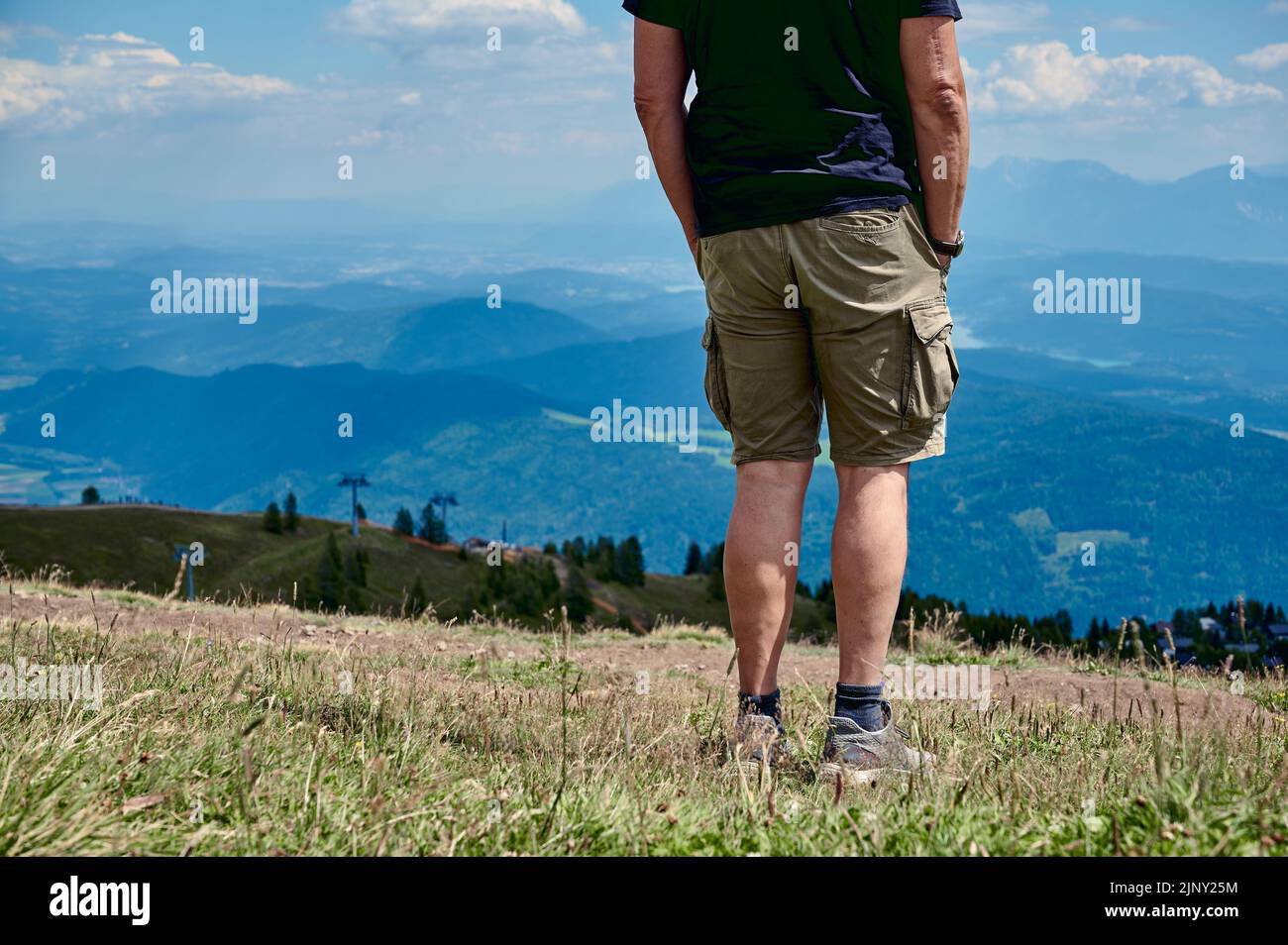 man on top of Gerlitzer Alpe is looking into distance Stock Photo