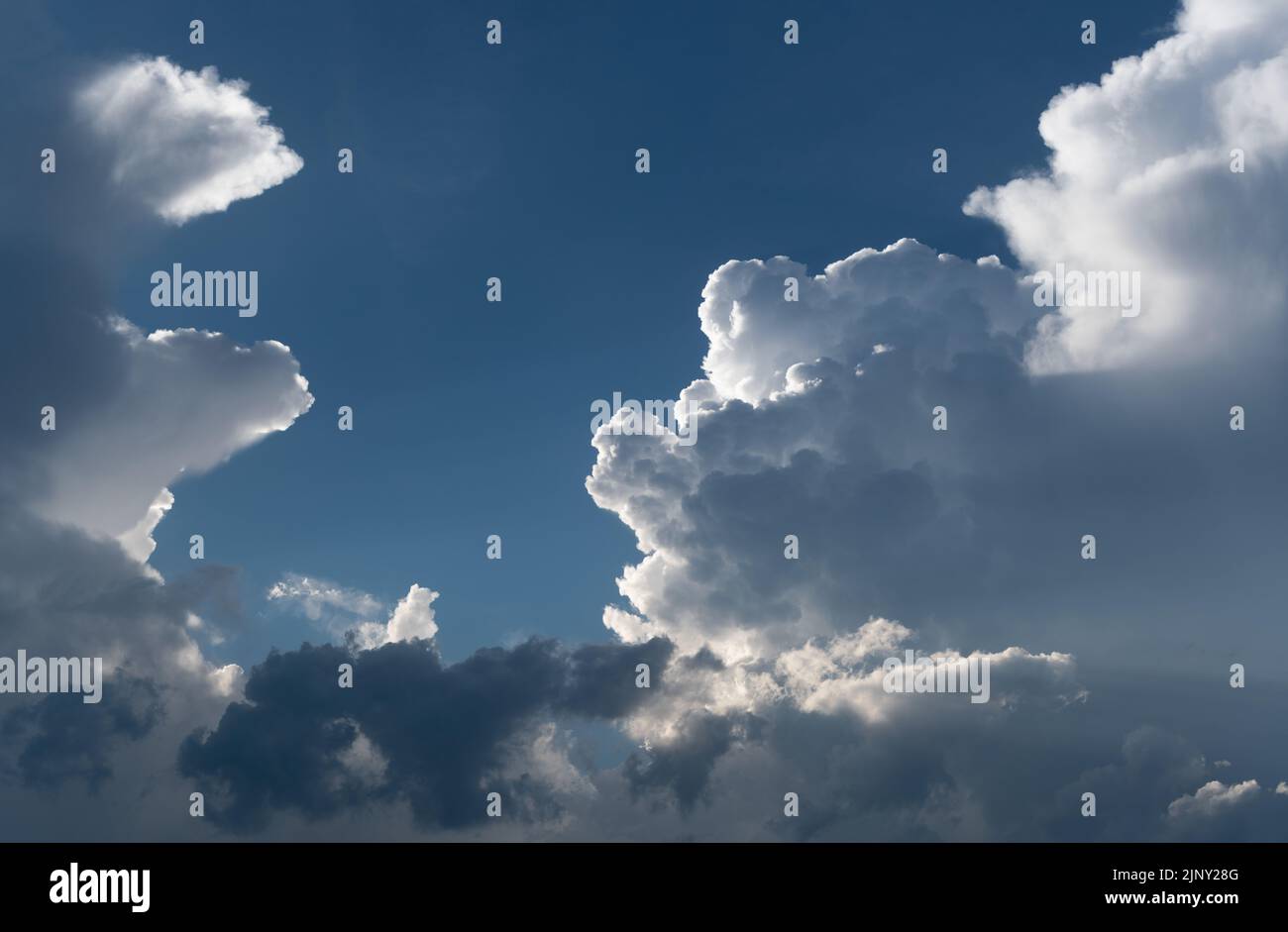 Big cloud in sky in dramatic sunlight close up, cloudscape panorama Stock Photo
