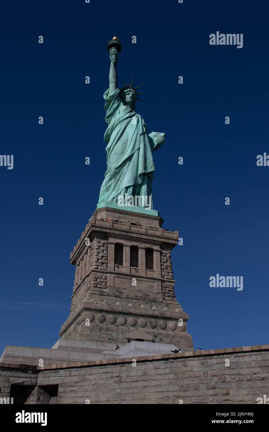 Statue of Liberty standing on Liberty Island, New York, New York, United States of America USA Stock Photo