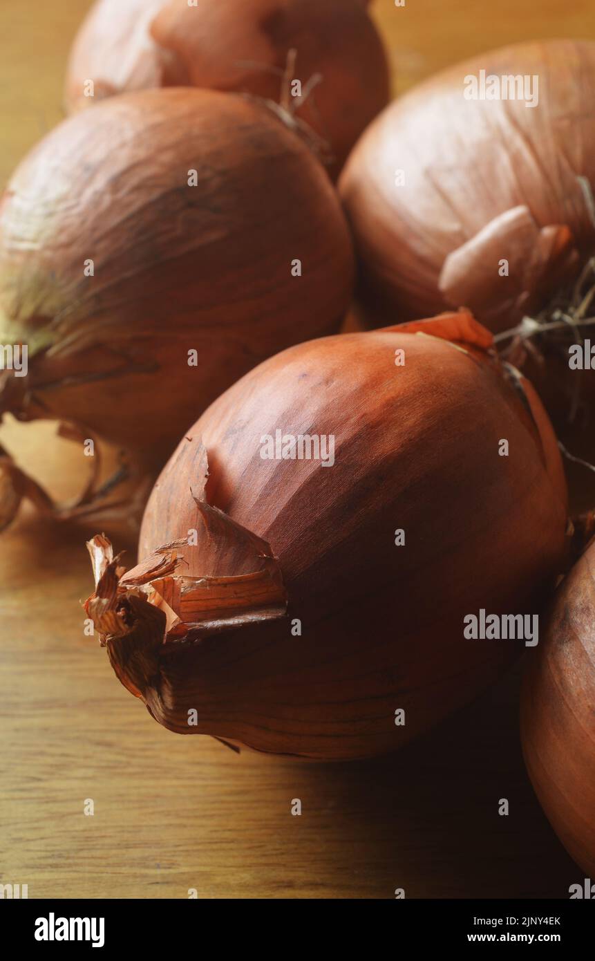 Raw onions in group on tabletop Stock Photo Alamy
