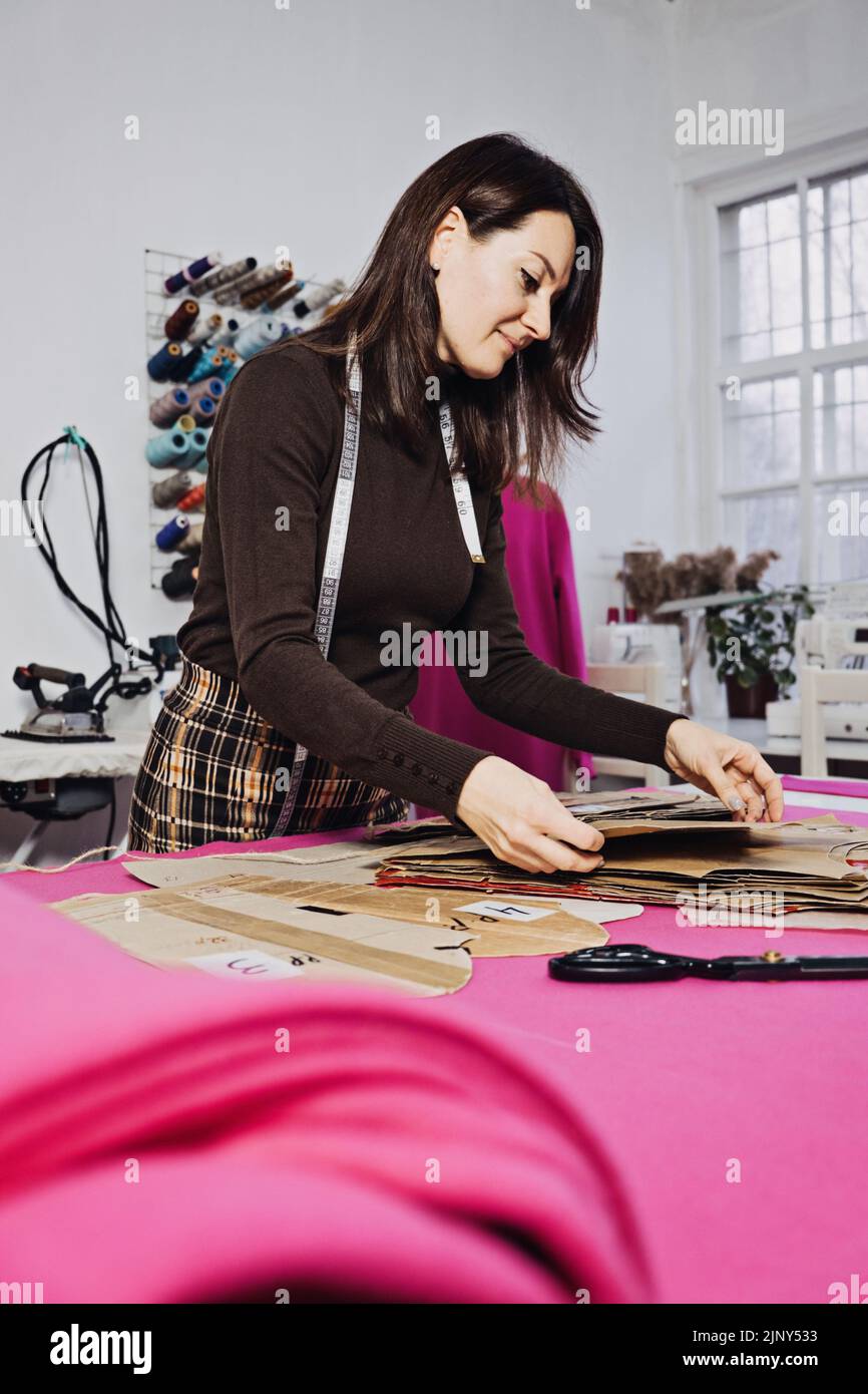 Hand Cutting Pattern and Fabric Pieces. Fashion Design. Female tailor ...