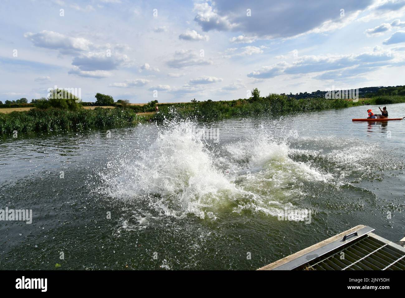 Saltford  Bath, UK. 14th Aug, 2022. UK Weather. On a very very hot day at Saltford  Near Bath, four boys from Radstock in Somerset are seen Jumping for Joy into the river Avon for a quick cooling off. Picture Credit: Robert Timoney/Alamy Live News Stock Photo