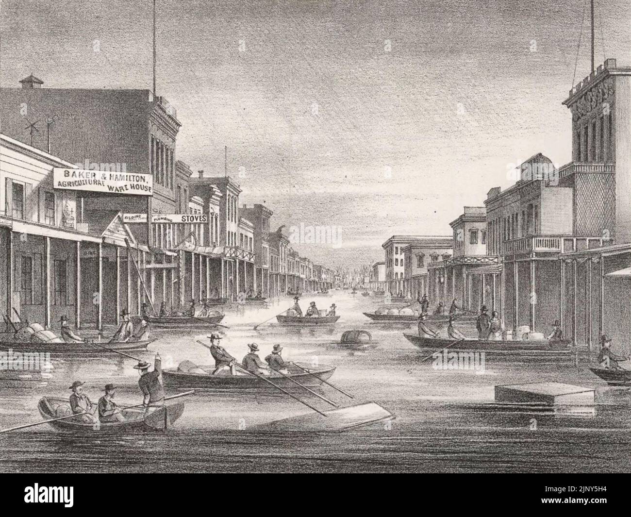 Inundation of the State Capitol, city of Sacramento, 1862 - J street in downtown Sacramento seen from levee showing flood of 1862; people in boats make their way between buildings in flooded city streets - California Flood, 1862 Stock Photo