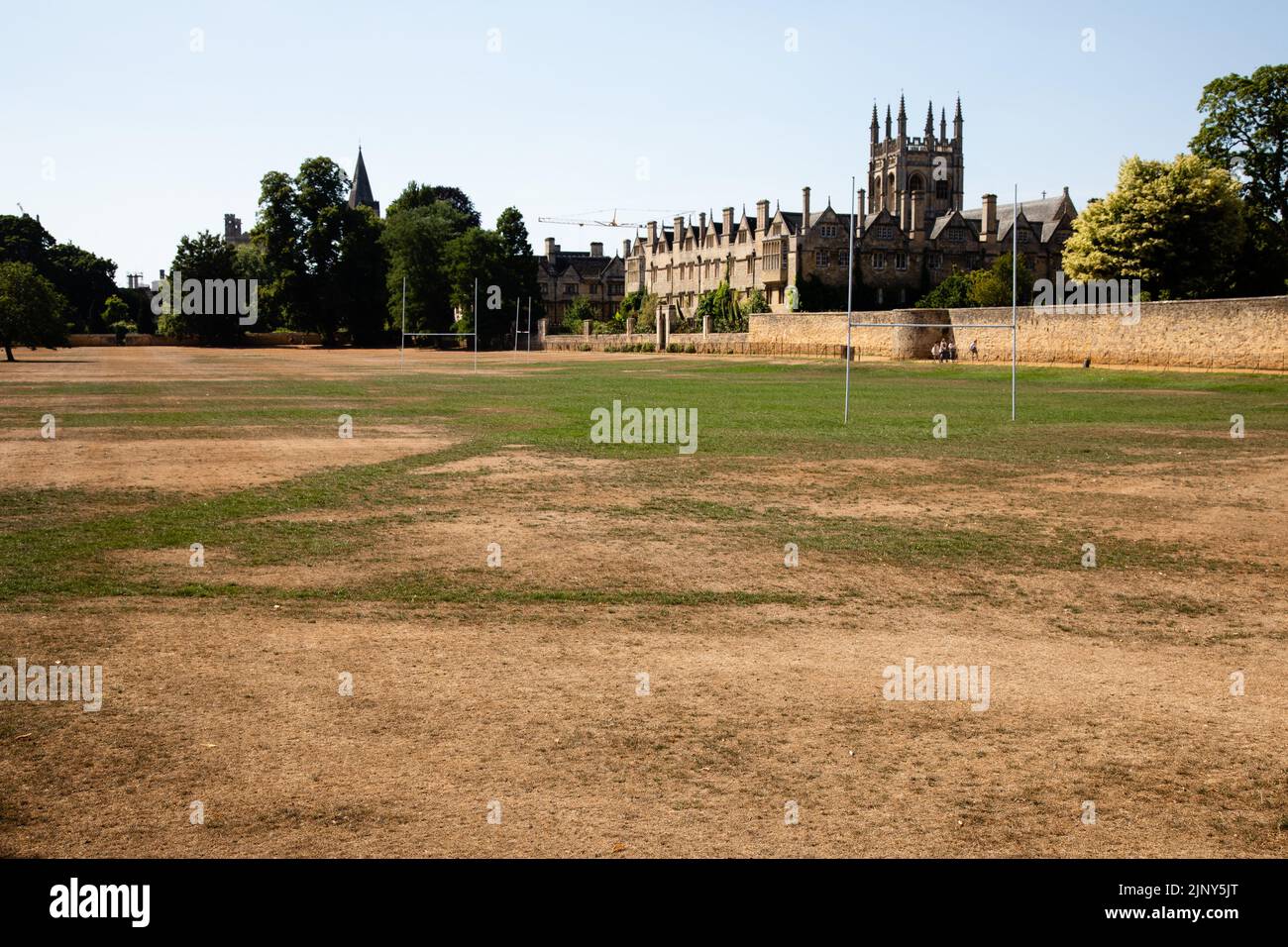 Oxford, UK. 12th August, 2022. Merton College is viewed across a parched Merton Field. Hot and dry conditions continue across the south of England wit Stock Photo