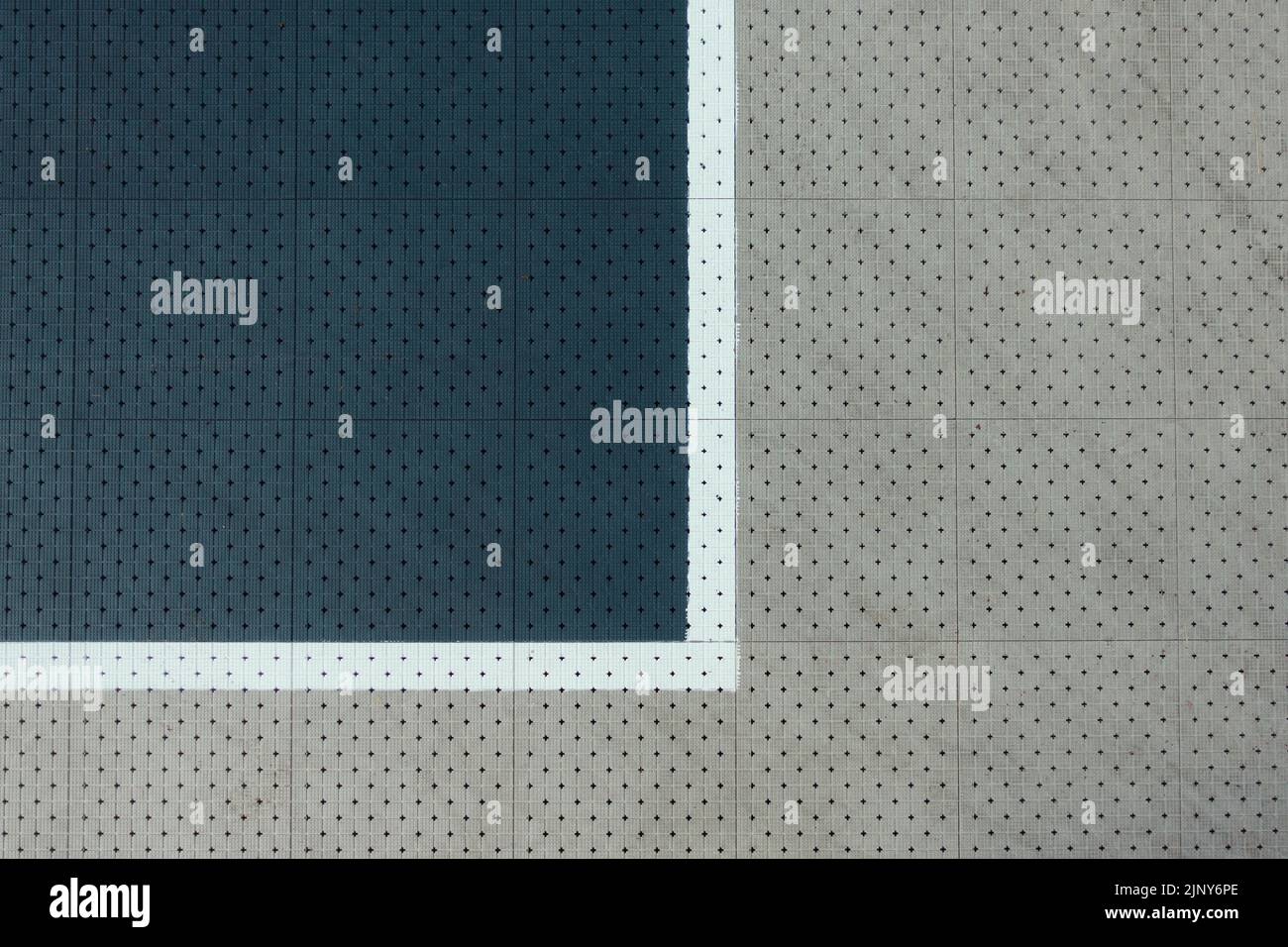 Gray color plastic covering of sports field, courtyard background. Basketball, volleyball ground