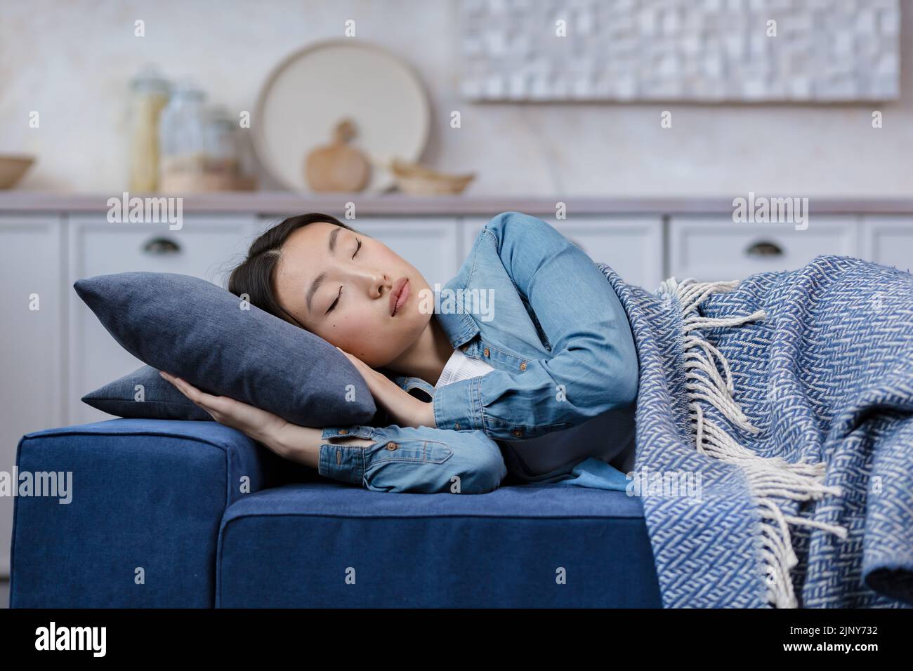 Closeup photo of a young beautiful Asian woman sleeping at home lying