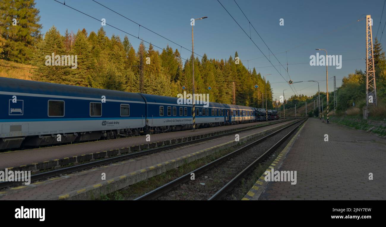 Trains in Strba station under Vysoke Tatry mountains in summer morning ...