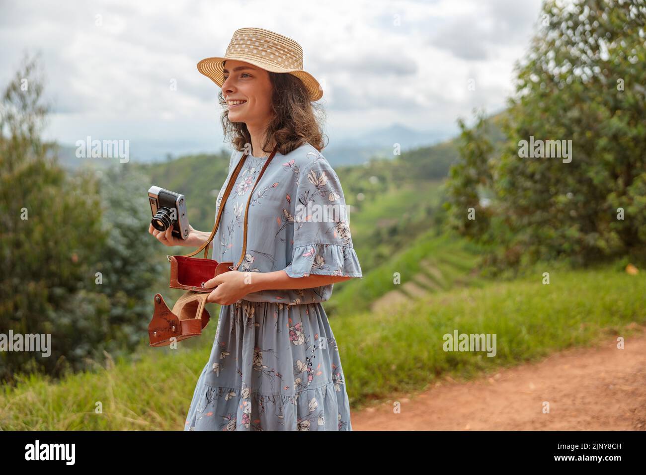 Happy pretty woman walking along African village Stock Photo - Alamy