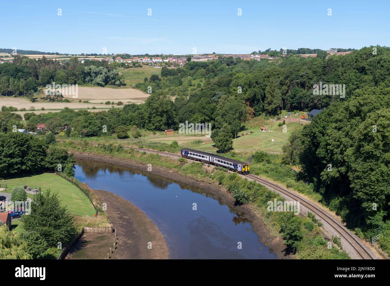 Northern Rail class 156 Diesel multiple unit train passing by the river