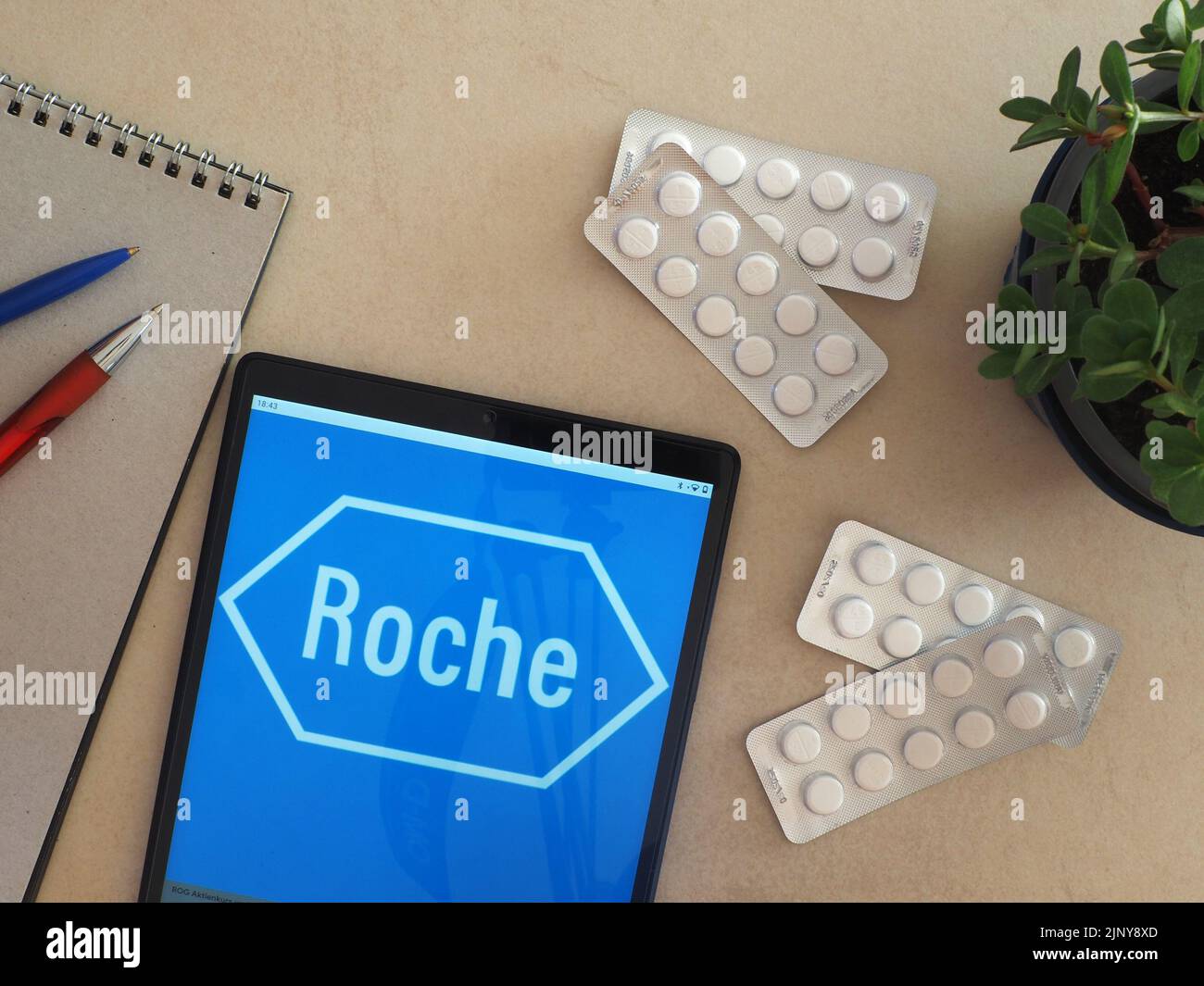 In this photo illustration, Roche Group logo seen displayed on a tablet Stock Photo