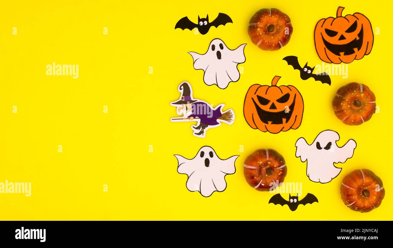 Creative yellow background with copy space and Halloween stickers. Flat lay Stock Photo