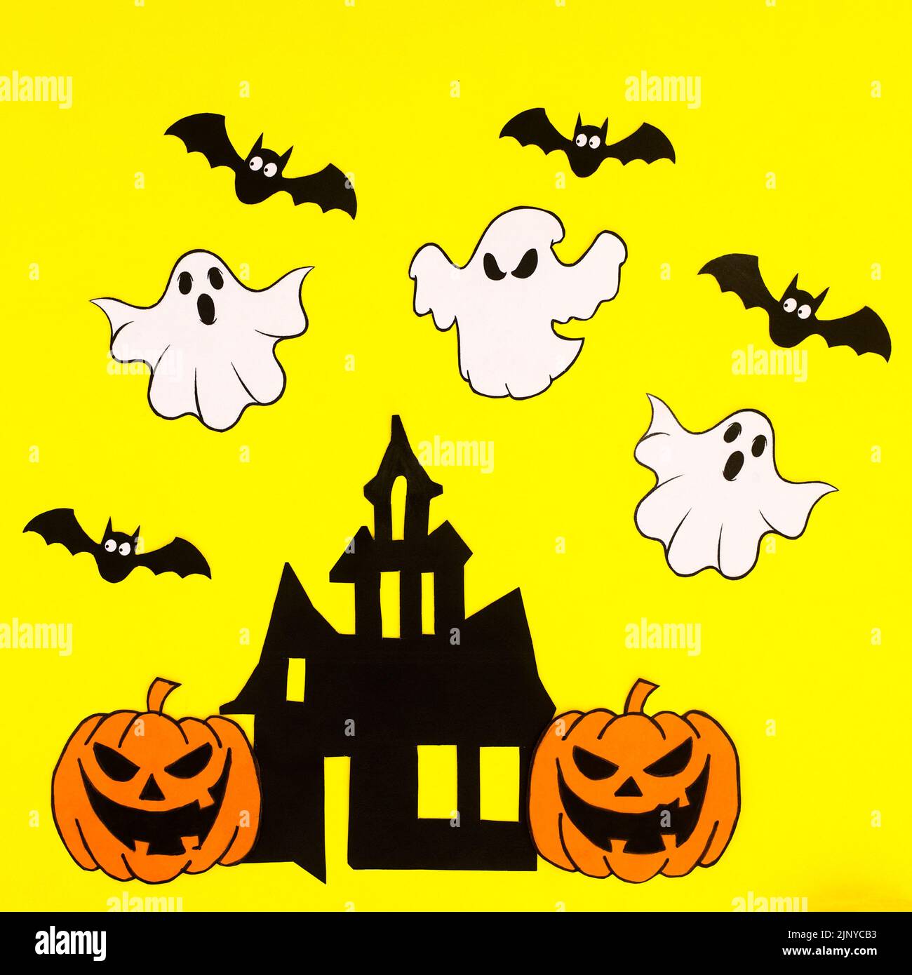 Yellow background with creative arrangement of creepy Halloween stickers. Flat lay Stock Photo