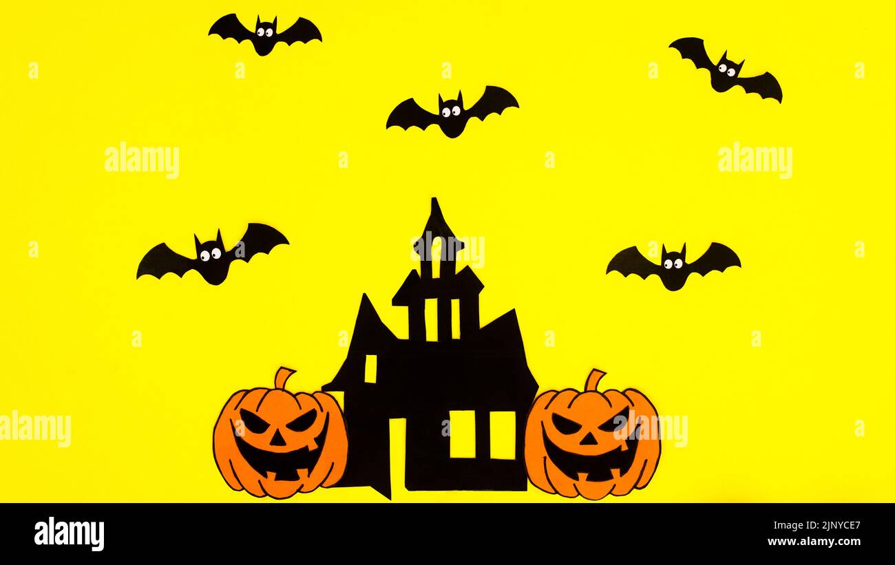 Yellow background with creative arrangement of creepy Halloween stickers. Copy space flat lay Stock Photo