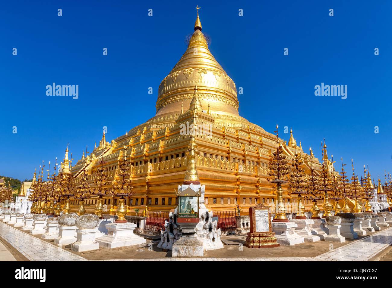 The Shwezigon Pagoda in Bagan, Myanmar. Consists of a circular gold leaf-gilded stupa surrounded by smaller temples and shrines Stock Photo
