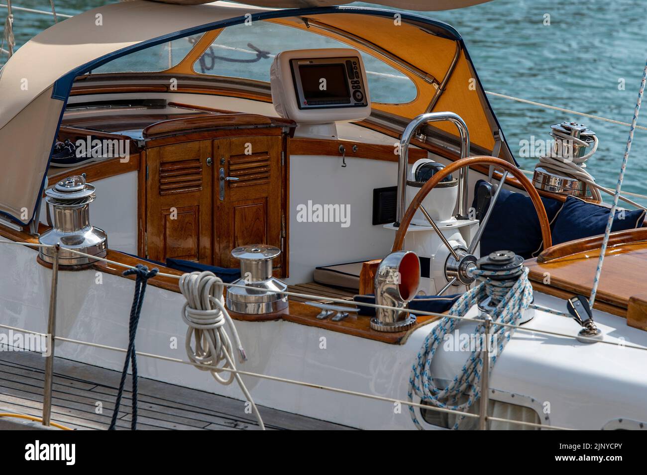 cockpit of a large offshore cruising yacht with teak cabin doors