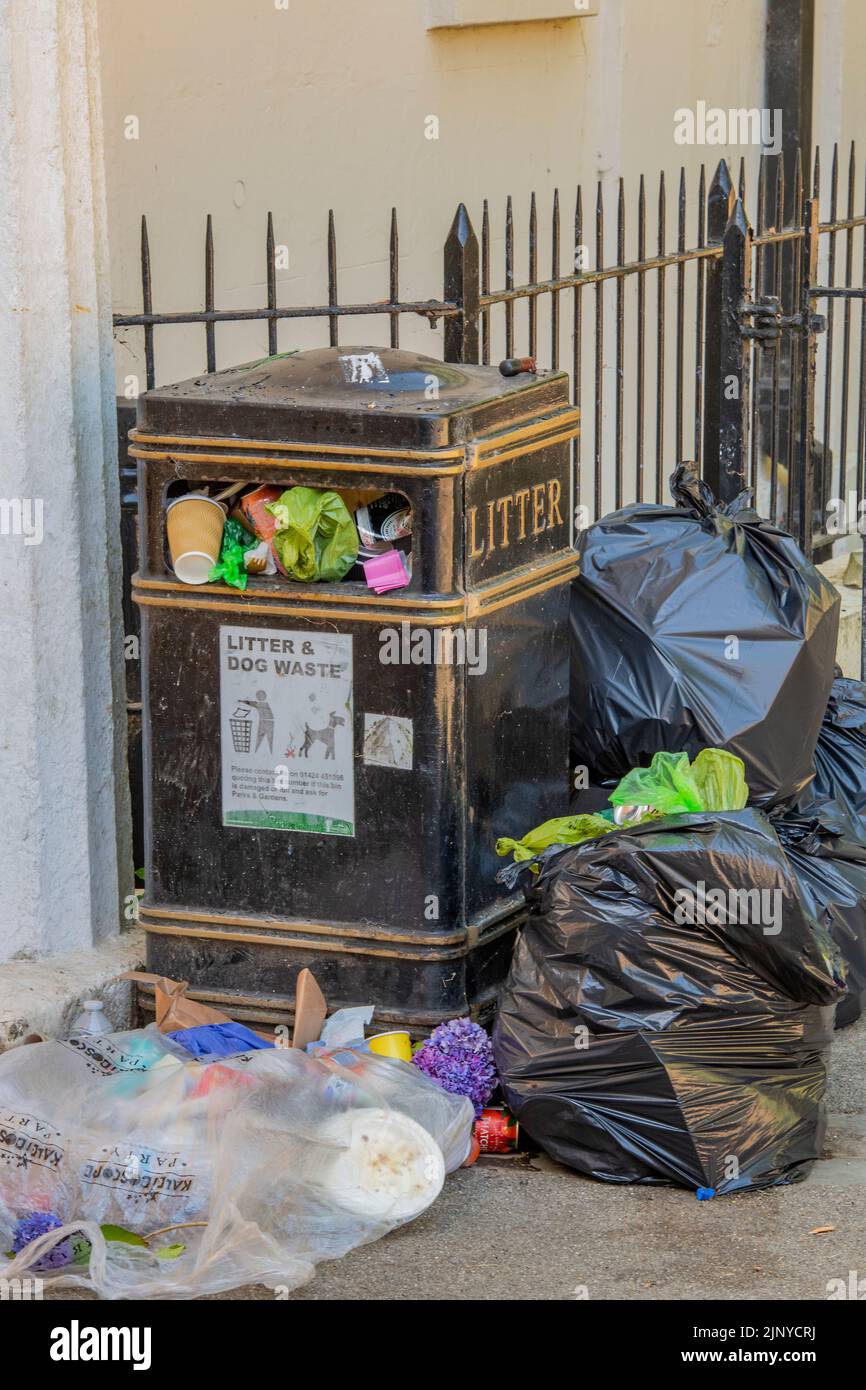 overflowing litter bin during a heatwave, litter overflowing from a