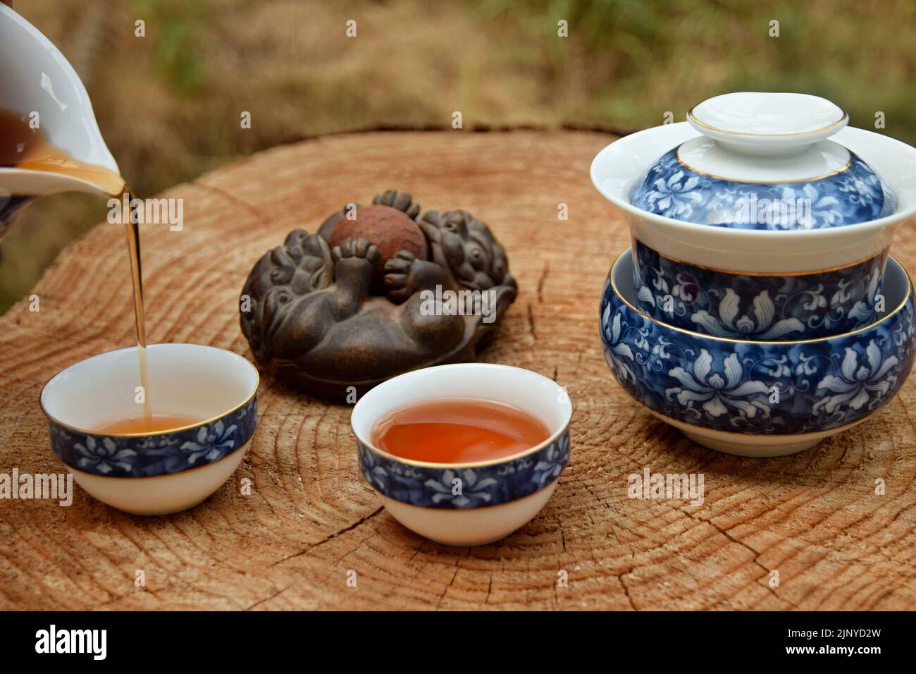 Preparing Chinese black tea in the tea set on the wooden table. Drink