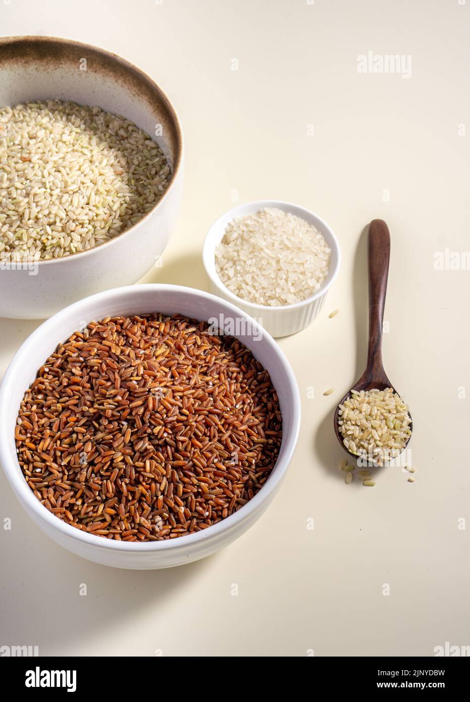 Uncooked rice assortment in bowl on white background. Top view Stock ...