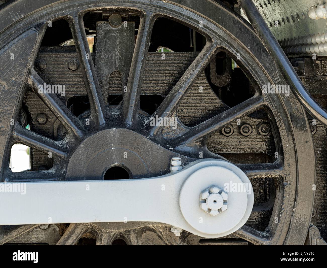 Steel train wheel close up with cross arm painted gray Stock Photo