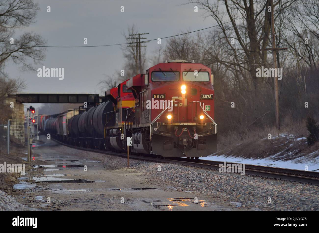 Wayne, Illinois, USA. A pair of locomotives, led by an off-road Canadian Pacific Railway unit, power a Canadian National Railway freight train. Stock Photo