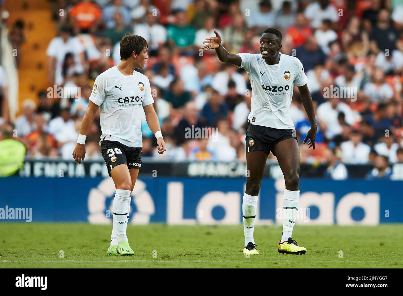 Valencia, Spain. . 14th Aug, 2022. Spanish La Liga: Valencia CF v Girona FC. Mouctar Diakhaby and Jesus Vazquez of Valencia CF Credit: saolab/Alamy Live News Stock Photo