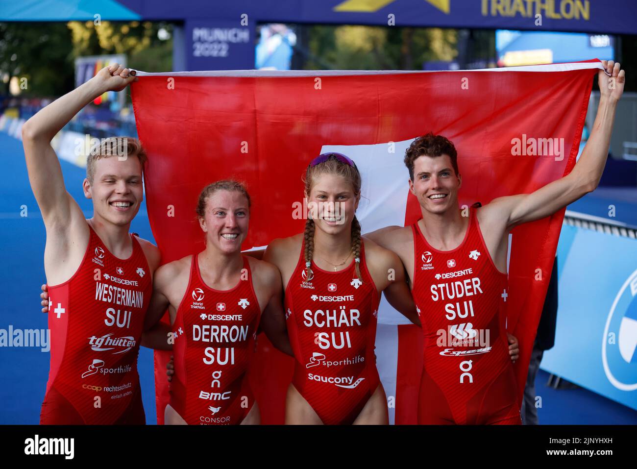 Munich, Germany. 14th Aug, 2022. European Championships, Triathlon, Relay, Mixed, in the Olympic Park. The third-placed team from Switzerland with Max Studer, Julie Derron, Simon Westermann and Chathia Schär on the podium. Credit: Jean-Marc Wiesner/dpa/Alamy Live News Stock Photo