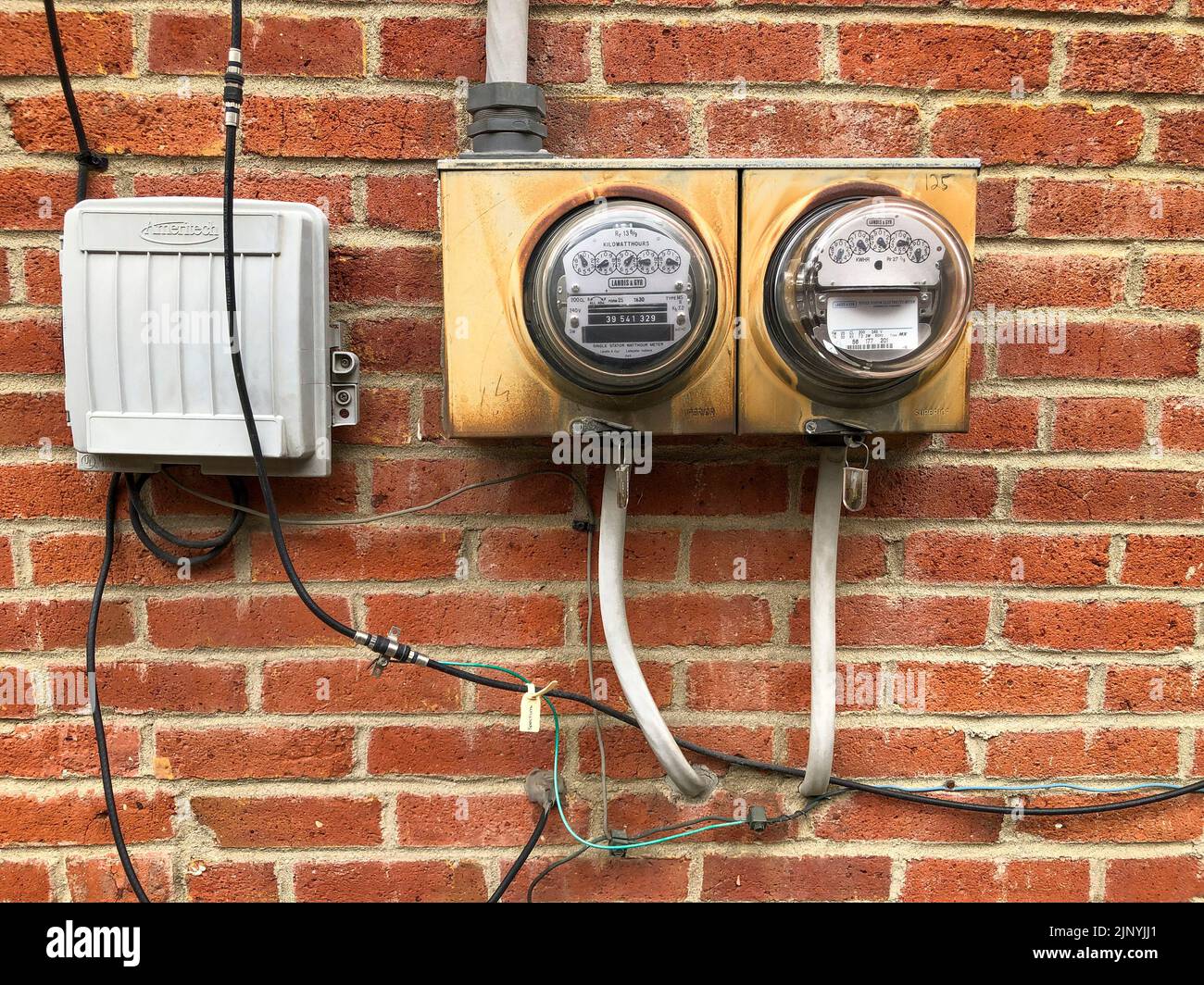 Household electricity meters in German Village, Columbus, Ohio, USA, August 2022 Stock Photo