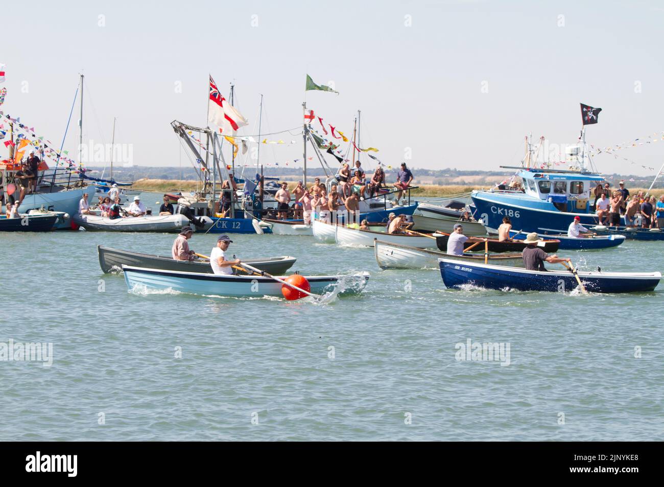 West Mersea regatta on Mersea Island in Essex. The regatta has been run almost continually since 1838 and is organised by volunteers. Rowing race. Stock Photo